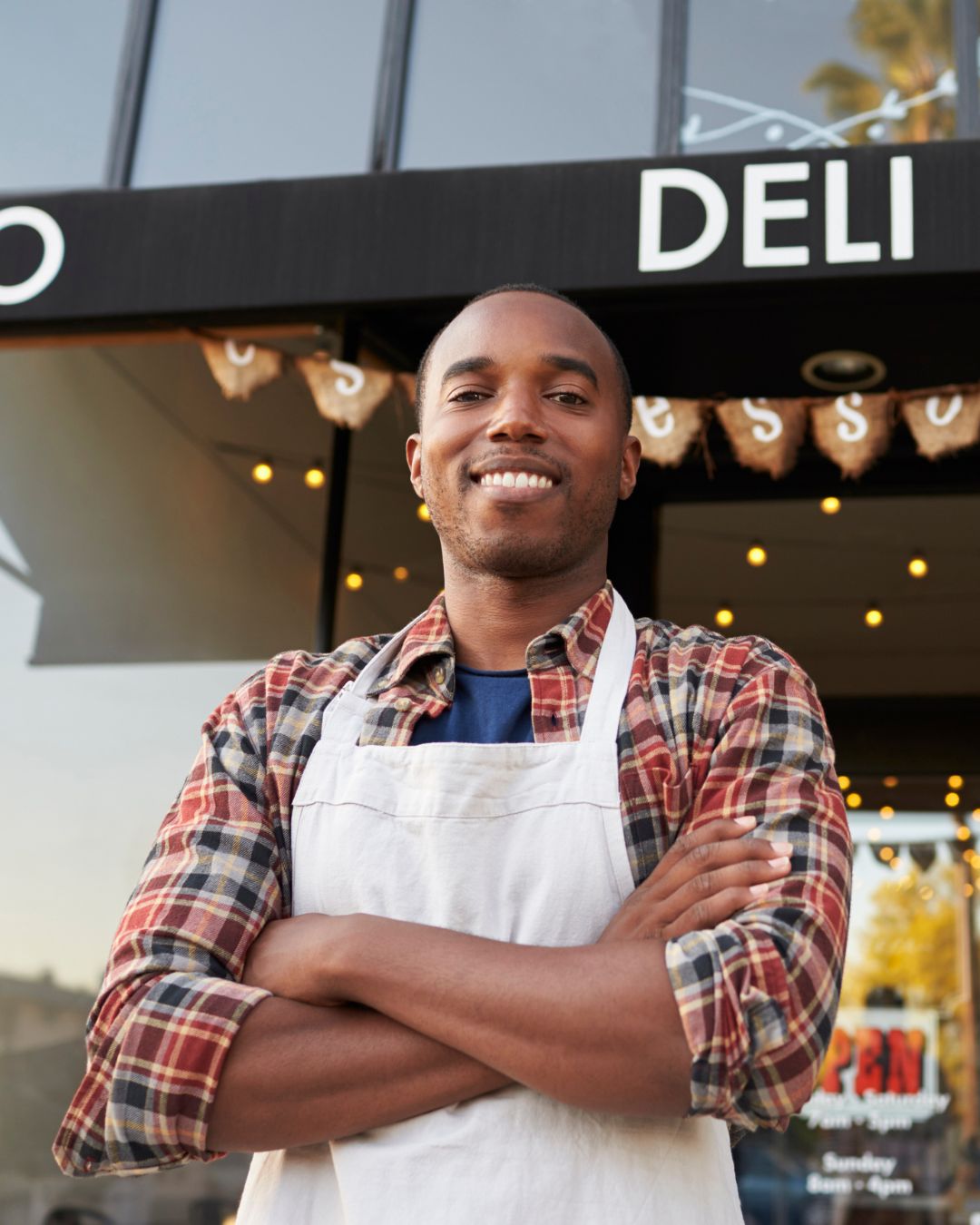 Deli and cafe owner poses for the camera